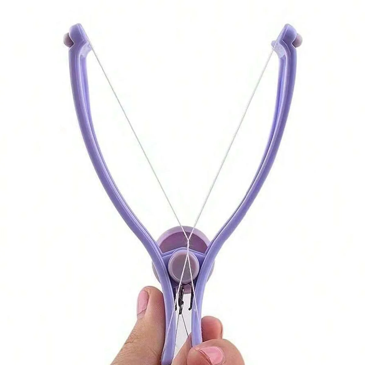 A hand holds a purple precision spring-action facial hair remover tool.