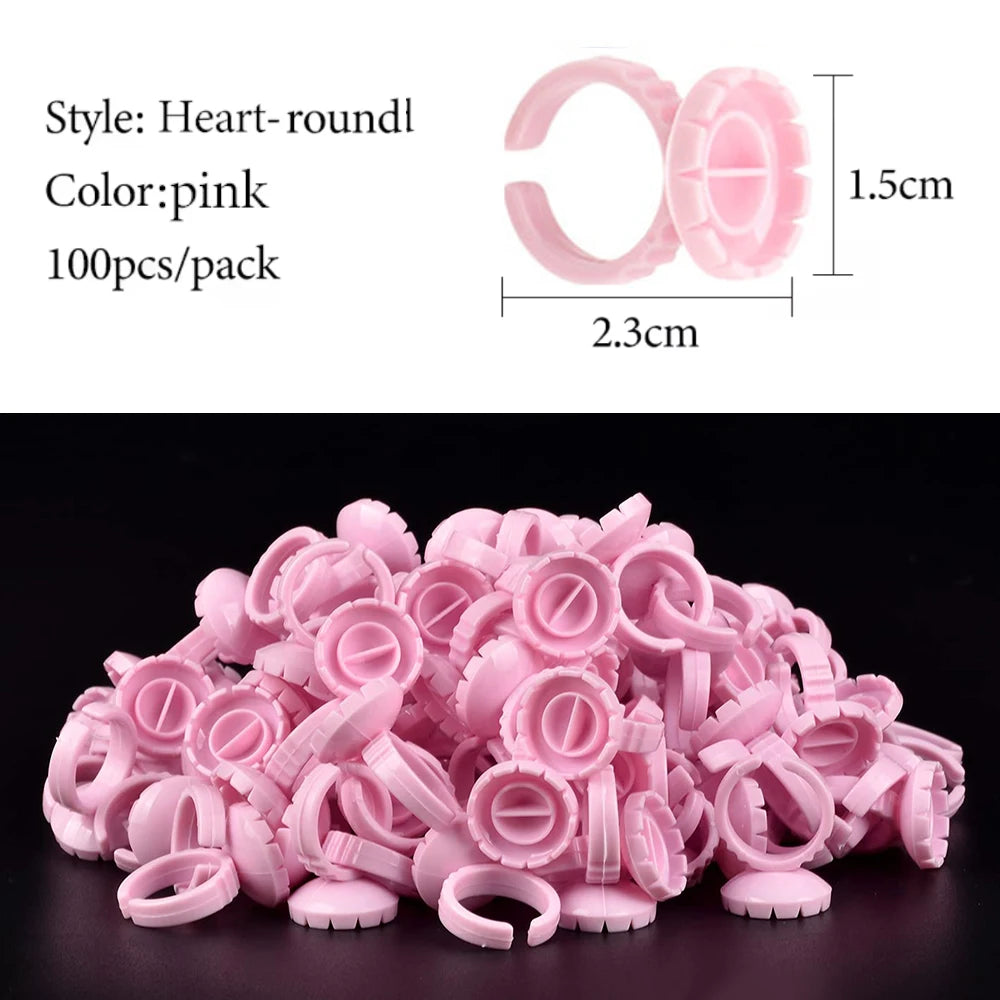 A pile of pink heart-round glue rings for eyelash extensions and nail art