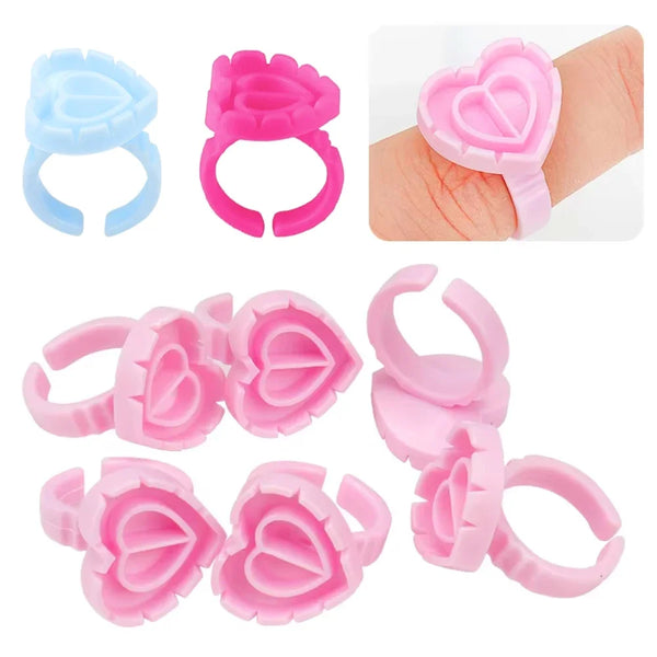 Assortment of pink and blue disposable glue rings for eyelash extensions and nail art