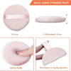 Pink dual-sided powder puff with a ribbon, showing its soft and fluffy texture.