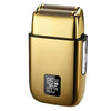 A gold-colored reciprocating electric shaver with a textured head and a digital display showing 100% power left.