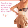A woman wearing a black garment with a mesh support underneath, demonstrating a comfortable fit without visible lines.