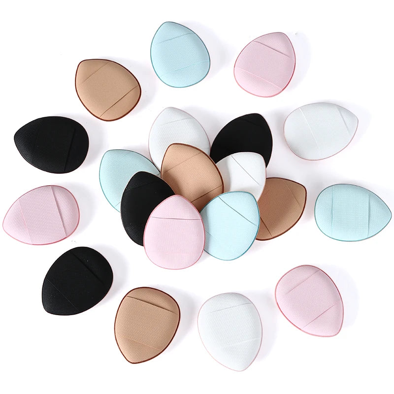 A collection of oval makeup sponges in various shades of pink, beige, and blue.