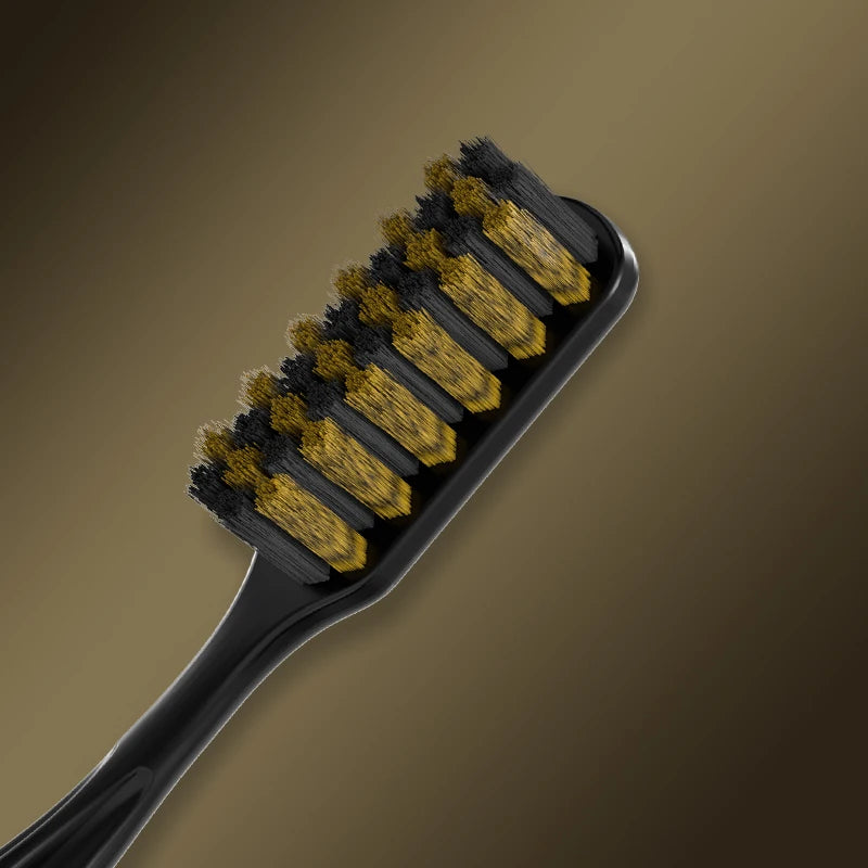 A black toothbrush with yellow bristles is shown against a brown background.