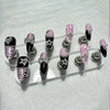 A set of glitter diamond press on nails featuring black, pink, and zebra print designs.