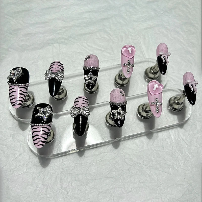 A set of glitter diamond press on nails featuring black, pink, and zebra print designs.