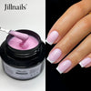Un pot de constructeur de gel liquide rose pour extensions d'ongles, avec une spatule cosmétique.