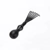 A black detangling scalp massage hairbrush with multiple fine bristles.