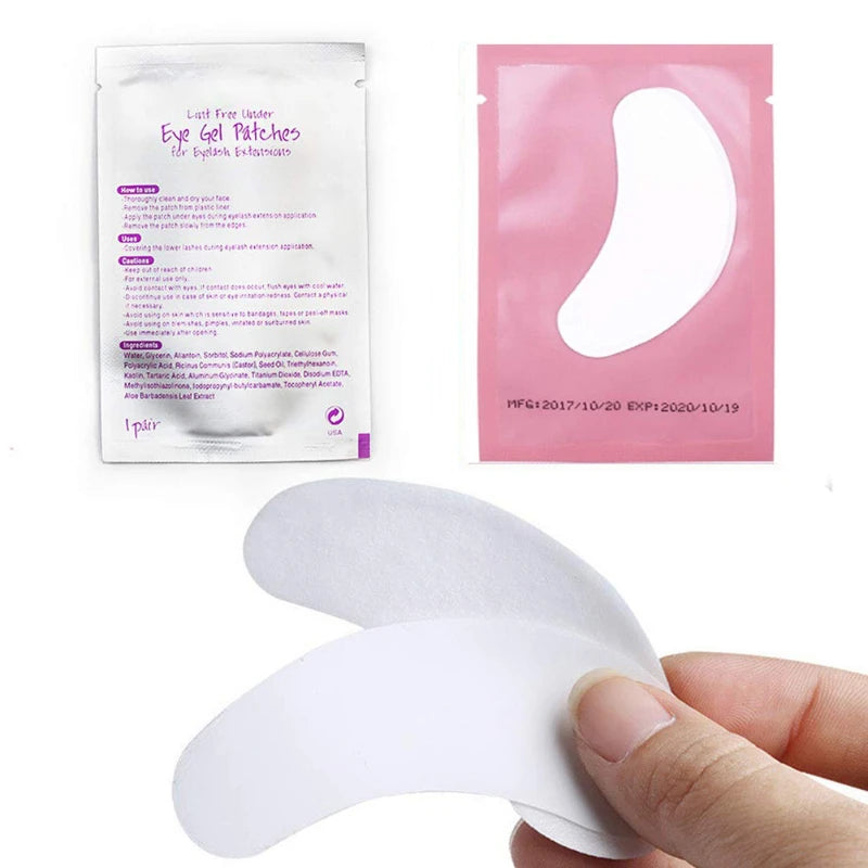 A package of Under-Eye Lash Application Patches and a single white eye patch being held by a hand.