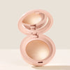 A pink liquid bronzer contour foundation stick is shown open, displaying the product inside.