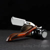 A silver professional manual shaver razor with a wooden handle and metal components.