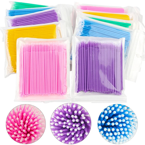 A collection of pink, purple, and blue precision eyelash cleaning and extension brushes in various packaging.