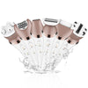 A set of six portable electric hair removers in rose gold and white are shown spraying hair onto a surface.