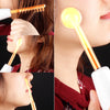 A close-up of a yellow high frequency facial rejuvenation device being used on a person's skin.