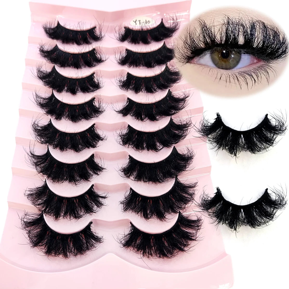 A set of natural mink striped false eyelash extensions displayed on a pink plastic tray with an eye example.