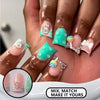 A close-up of a hand displaying various colorful and glittery press-on nails with various designs and charms.