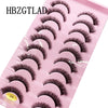 Plateau en plastique rose contenant divers styles de faux cils de renfort mink pour application.