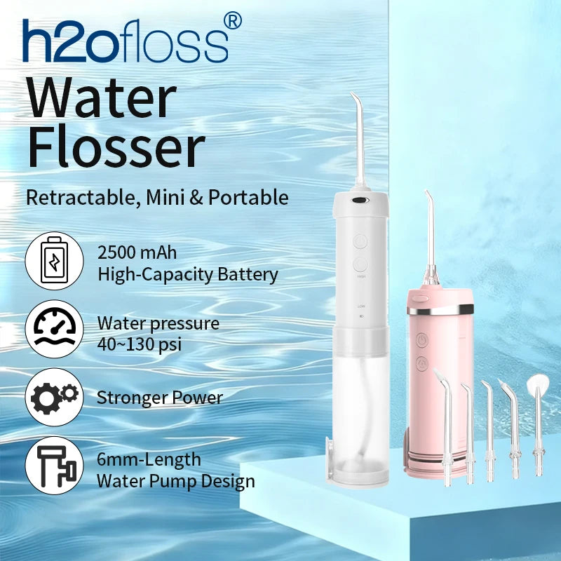 A white and pink portable water flosser device with a detachable tip and several attachments shown against a blue water backg