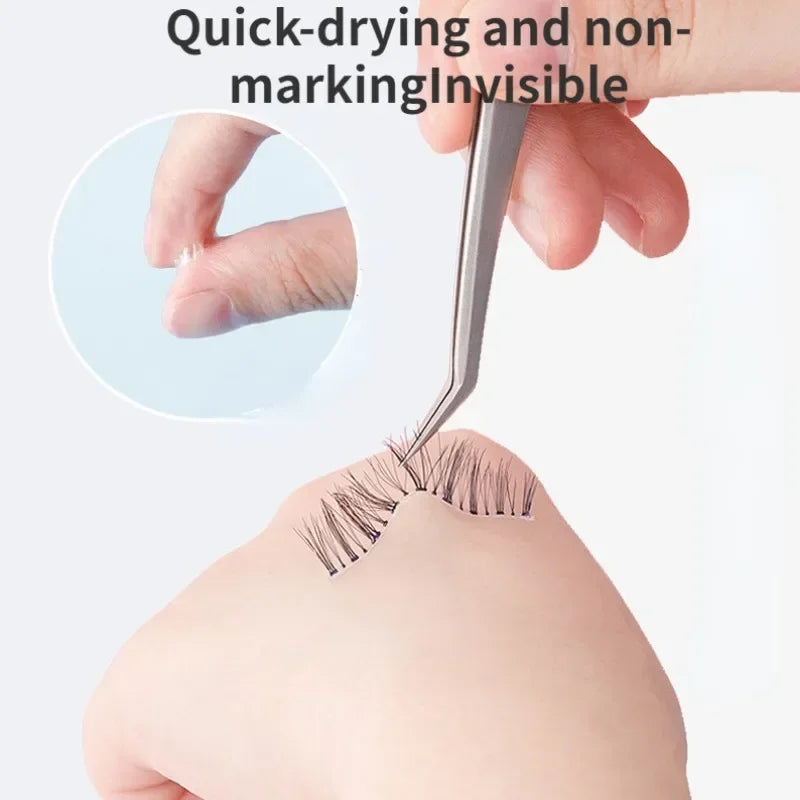 A hand is using a professional eyelash glue tool to apply adhesive to false lashes on an eyelid.