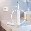 A white sonic electric toothbrush with a timer and 5 modes is shown on a counter next to a sink.