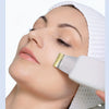 A woman is using an Ion Technology deep pore cleansing device on her face.