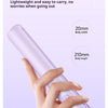 A hand is holding a light purple hair styling tool, demonstrating its size and portability.