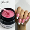 Une main montre des extensions à ongles roses et blanches appliquées avec un constructeur de gel auto-nivelant Jillnails.
