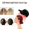 A black cap used for LED red light hair care therapy, shown on a person's scalp.