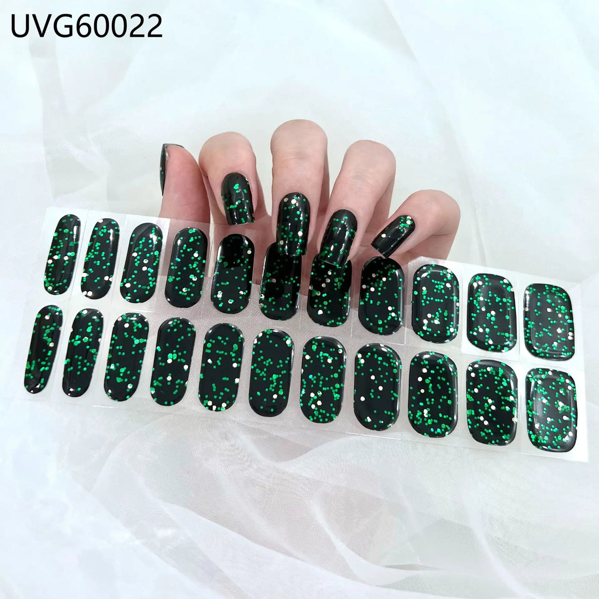 A hand displays various black and green glitter UV gel nail stickers for full coverage decals.