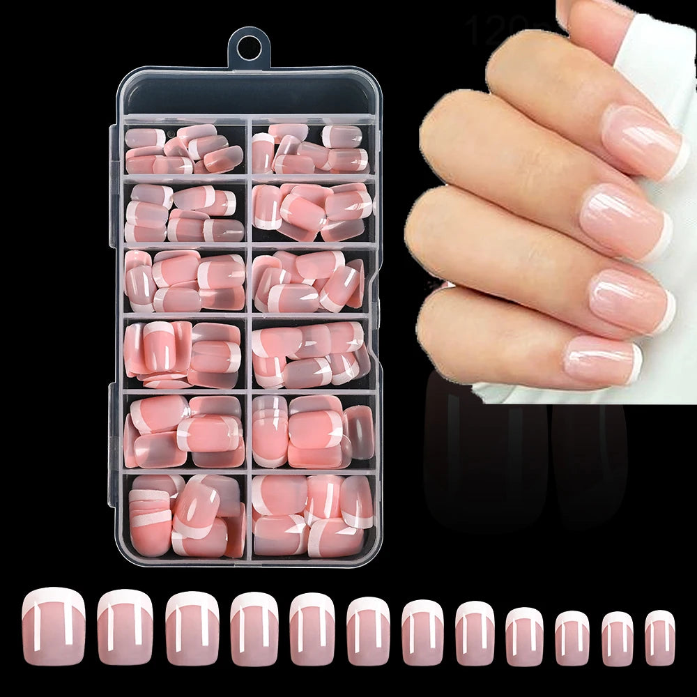 A set of nude pink press-on nails with white French tips displayed alongside a clear storage case and various nail shapes.