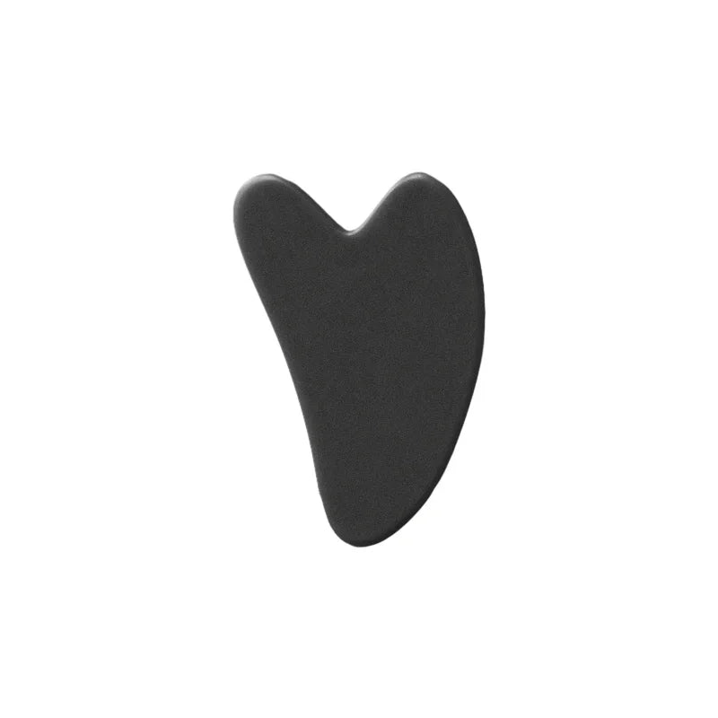 A black jade gua sha facial stone with a heart-shaped design.