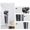 A silver electric shaver and trimmer device shown in three views, highlighting its design and features.