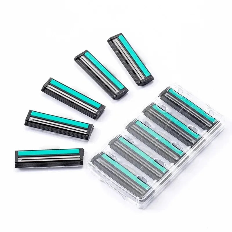 A set of double blade replaceable shavers with silver and teal colored blades arranged on a clear plastic tray.