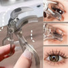 A clear dual-type eyelash curler with a comb is shown being used on an eye.