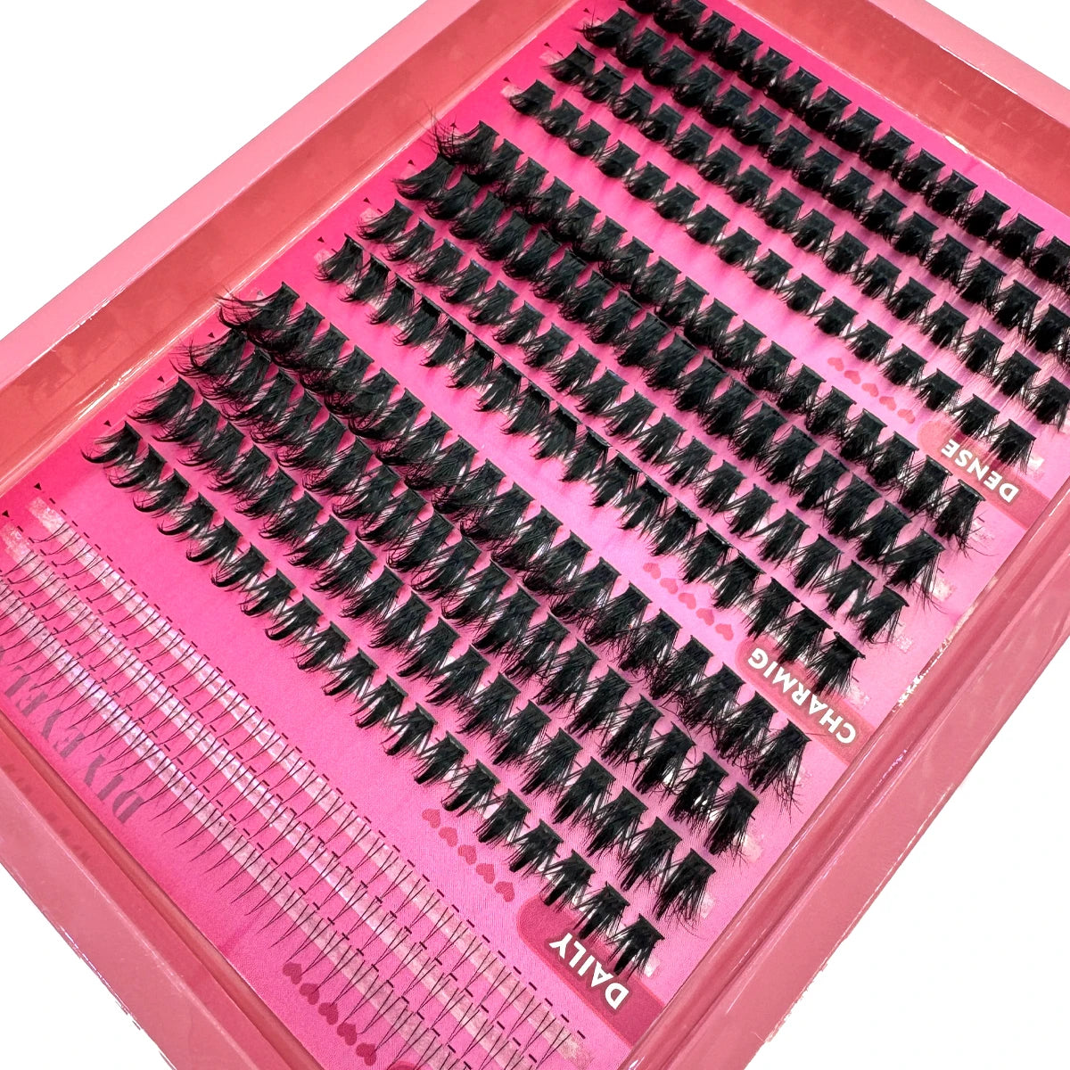 A pink tray of manga lash clusters with bottom and spikes for volume DIY eyelash extensions.