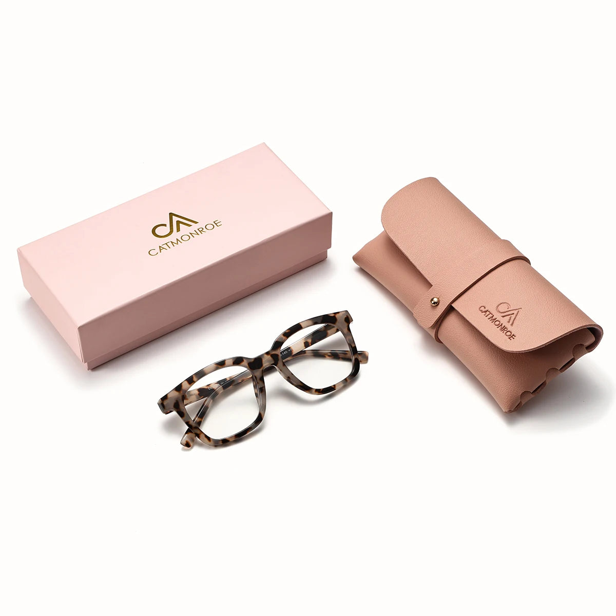 A pink box and a tan silk scarf with leopard print reading glasses.