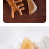 A set of amber-colored silicone facial massage and lifting tools, including a comb-like tool and a curved piece.