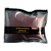 A black sealed pouch containing an African bath sponge for refresh and exfoliate.