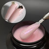 Un constructeur de gel de milieu rose auto-nivelant pour extensions de ongles, présenté dans un pot avec une spatule cosmétiq