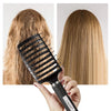 A black curved vented hair brush is shown being used on light brown hair, demonstrating its detangling and blow-drying functi