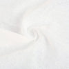 A close-up of white reusable compressed face towels made of a textured, absorbent fabric.