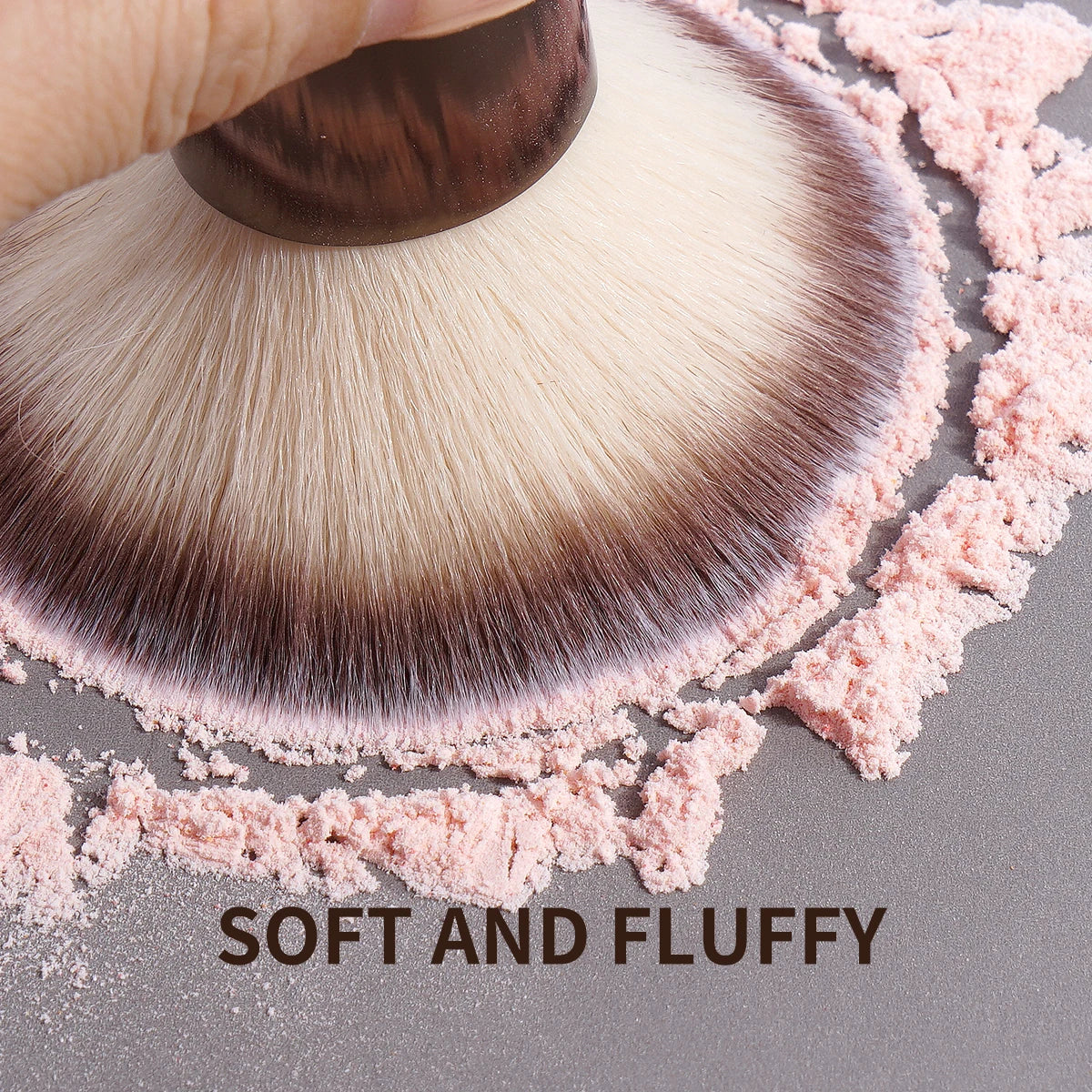 A close-up of a fluffy makeup brush with soft pink and brown bristles, labeled as soft and fluffy.