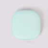 A round, light mint green compact LED makeup mirror with a smooth finish.