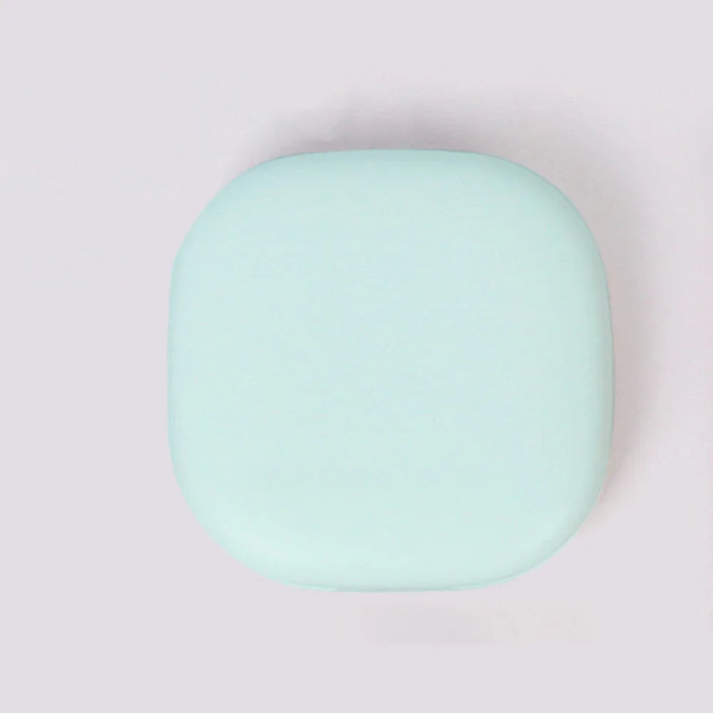 A round, light mint green compact LED makeup mirror with a smooth finish.
