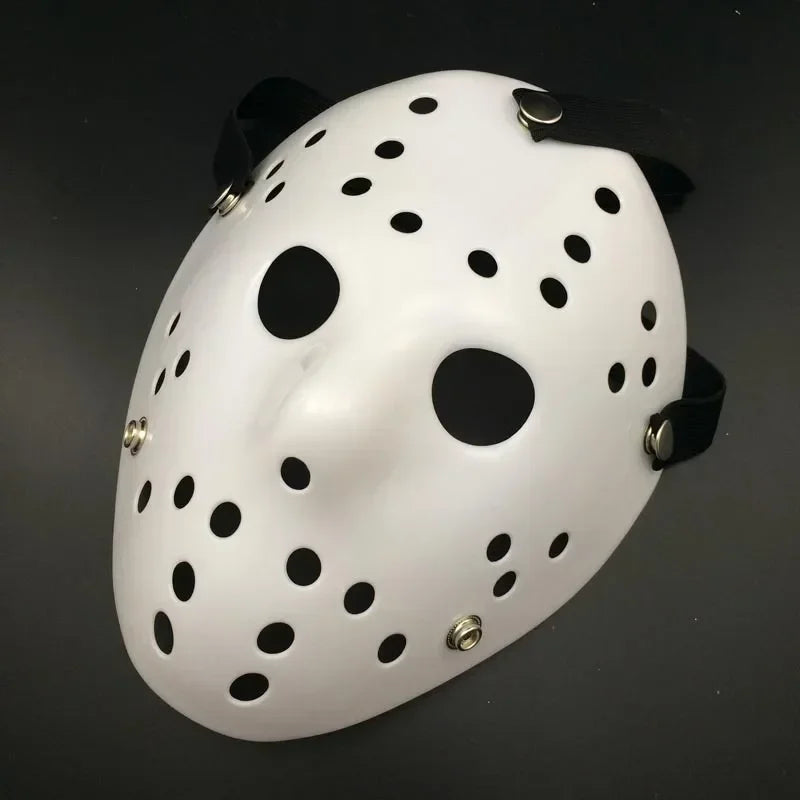 Masque de hockey blanc à pois noirs et œillets, utilisé comme masque Freddy pour une fête.