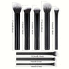 A set of nine different makeup brushes shown standing upright with their dimensions labeled.