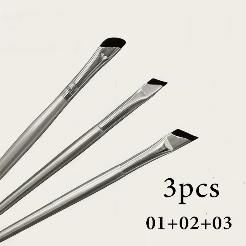 Three silver angled eyeliner brushes shown diagonally against a white background.