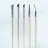 A set of professional angled makeup brushes with varying sizes and shapes displayed vertically.