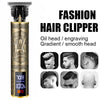 A gold-colored fashion hair clipper with an oil head and engraving gradient design shown in a vertical view.