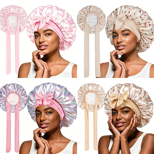 Four models wearing satin lace-up sleep bonnets in various shades of pink and beige